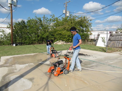 I'm in the one in blue and my brother is the one in the back...My dad is using us as free labor to cut the concrete.