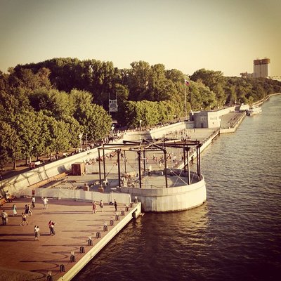 Summer evenings, people dancing by the riverside. Ordinary weekend.